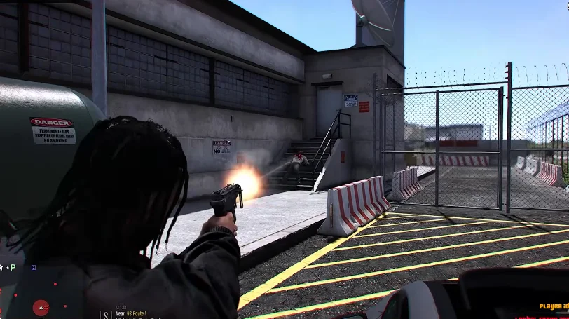 An image from the download GTA Mzansi Kasi Vibes in which a person is aiming a handgun at a building with a fence in an outdoor urban environment.