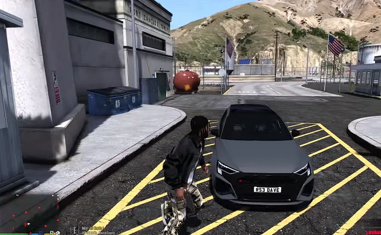 Kasi Vibes 16 A screenshot from gta mzansi kasi vibes app, in which a person standing near a parked grey car in an outdoor setting with buildings and mountains in the background.