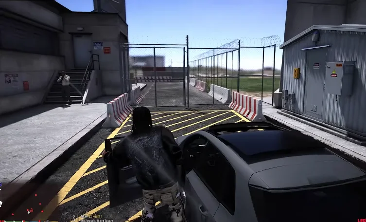 In a screenshot from gta mzansi kasi vibes files download, a person is entering a fenced area with a building in the background, near a parked car and a road with marked lanes.